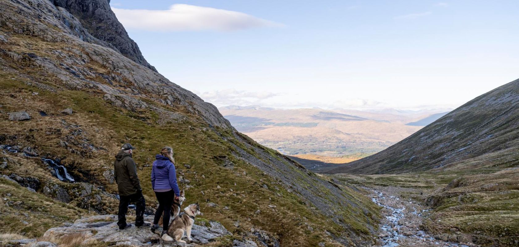 People hiking with huskies in Scotland