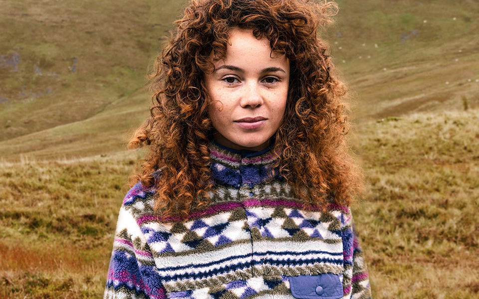 Ayacucho women's. A woman smiling wearing an Ayacucho fleece 