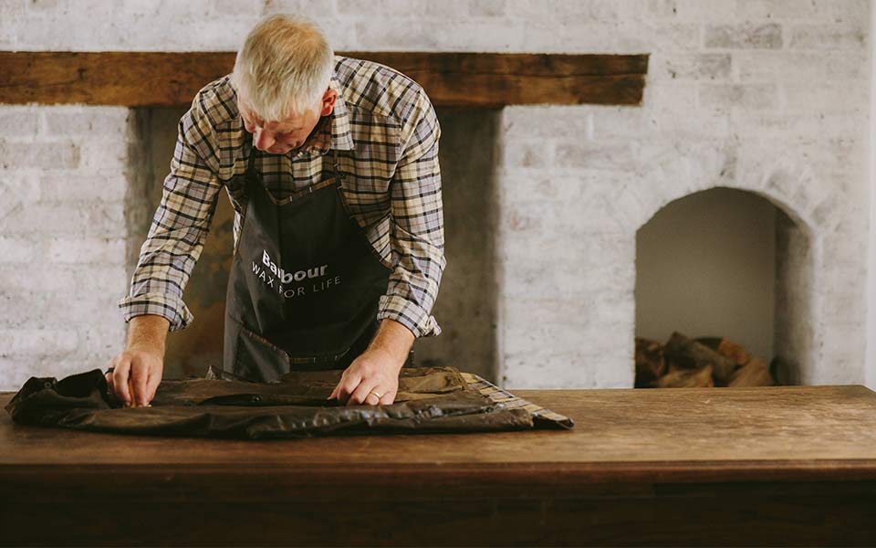 A man crafting Barbour clothing 