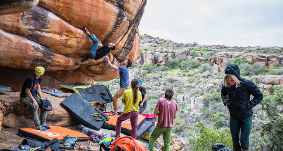 A group of people rock climbing with Mountain Hardware gear.