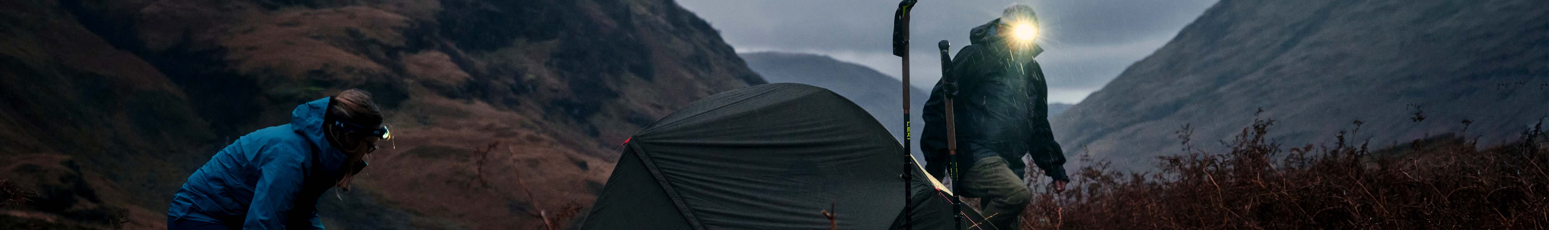 People camping using lighting gear