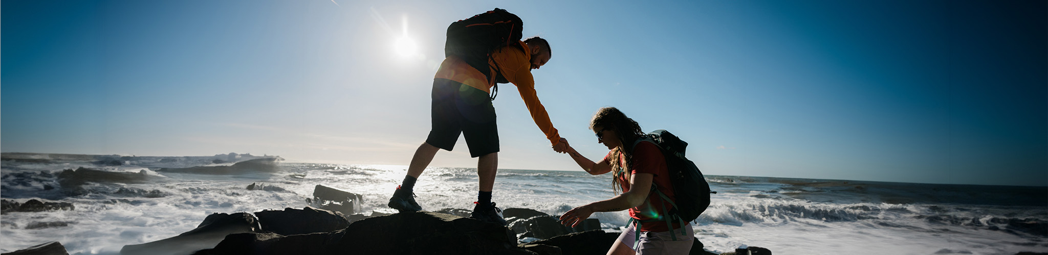 People walking on a rocky beach