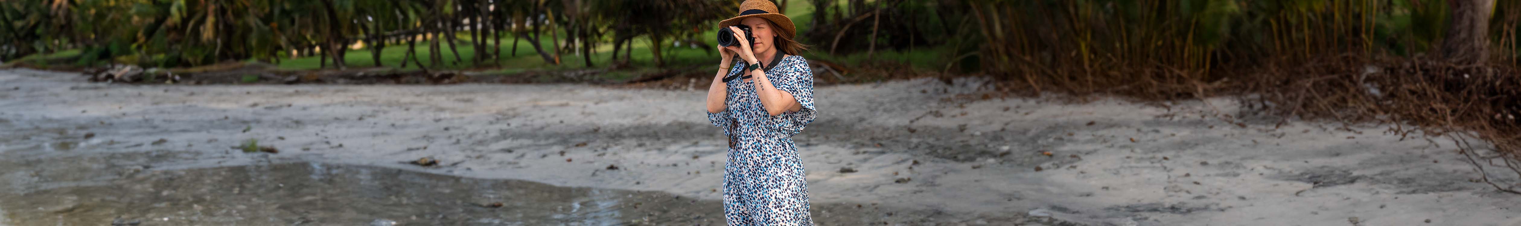 Woman taking a picture on a beach