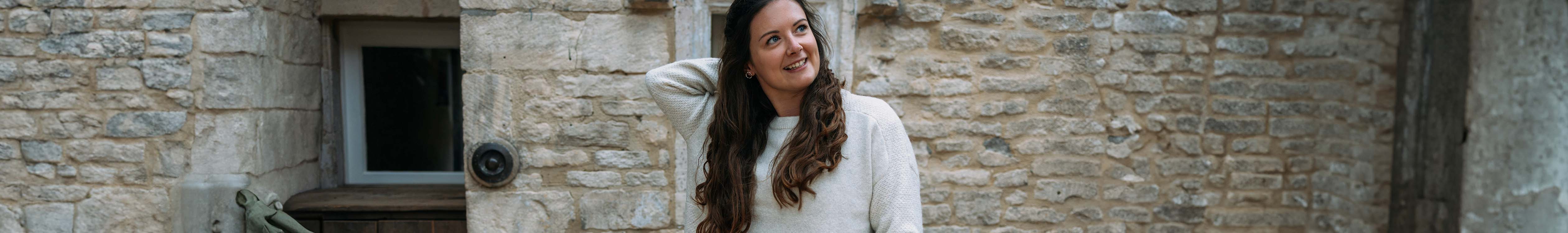 Woman walking outdoors wearing knitwear