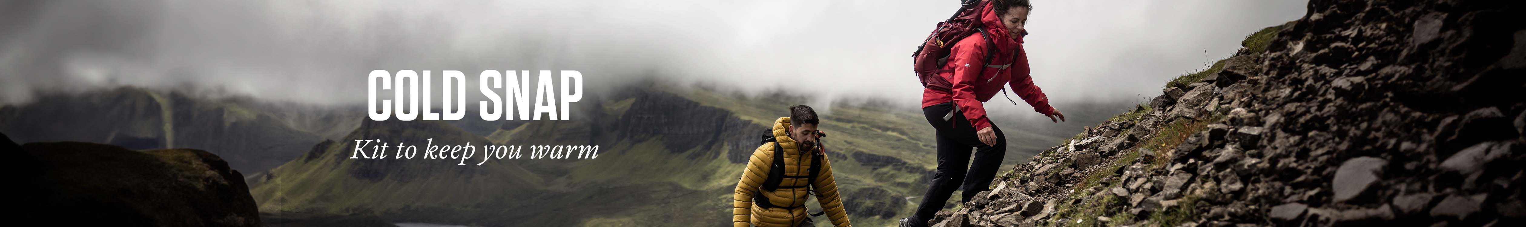 Two people, wearing jackets and rucksacks, are walking down a hill.  