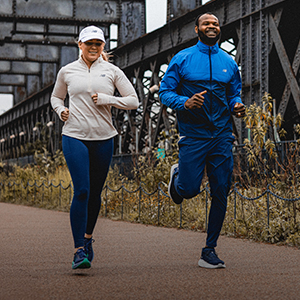 2 people running in urban area