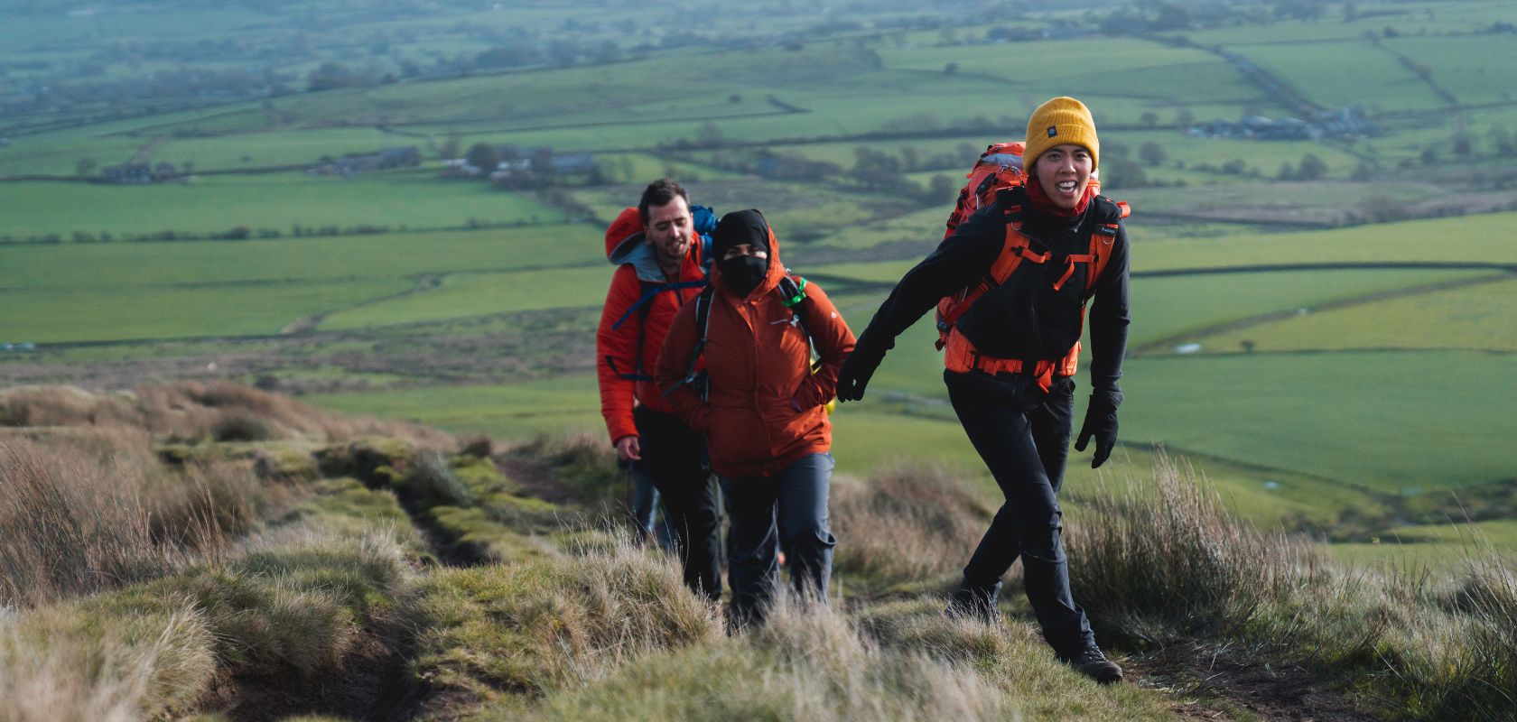 People hiking up a hill 