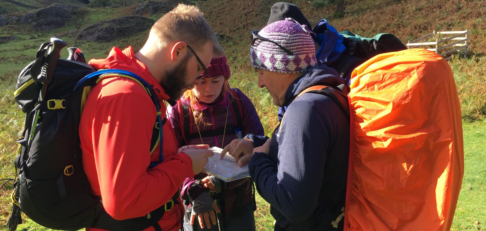 Hikers gathering around a map 