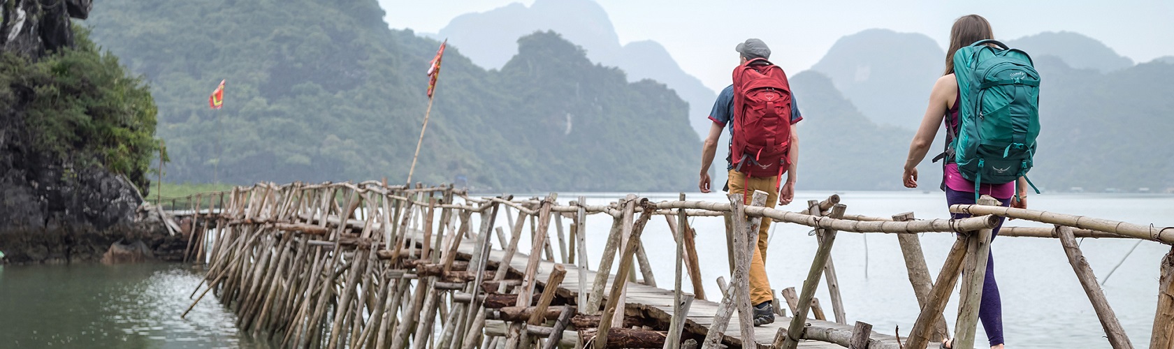 Eric Elofson and Ashley Buttelmann trek along a pier in Cat Ba National Park, Vietnam