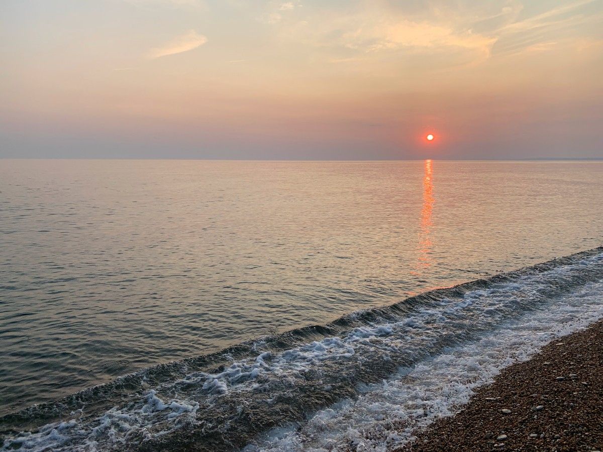 The sun setting over a beach in Weymouth