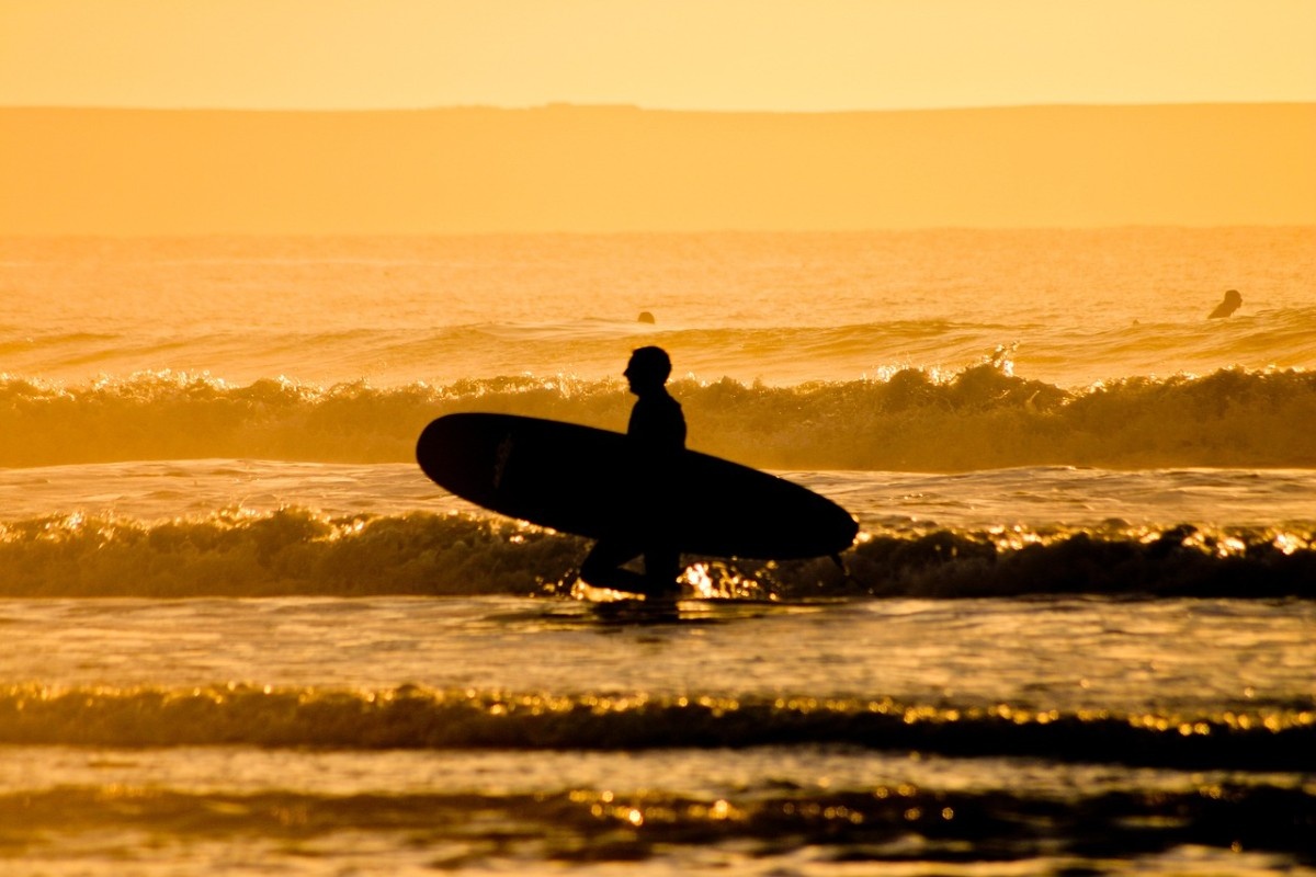 A surfer at Woolacombe Beach