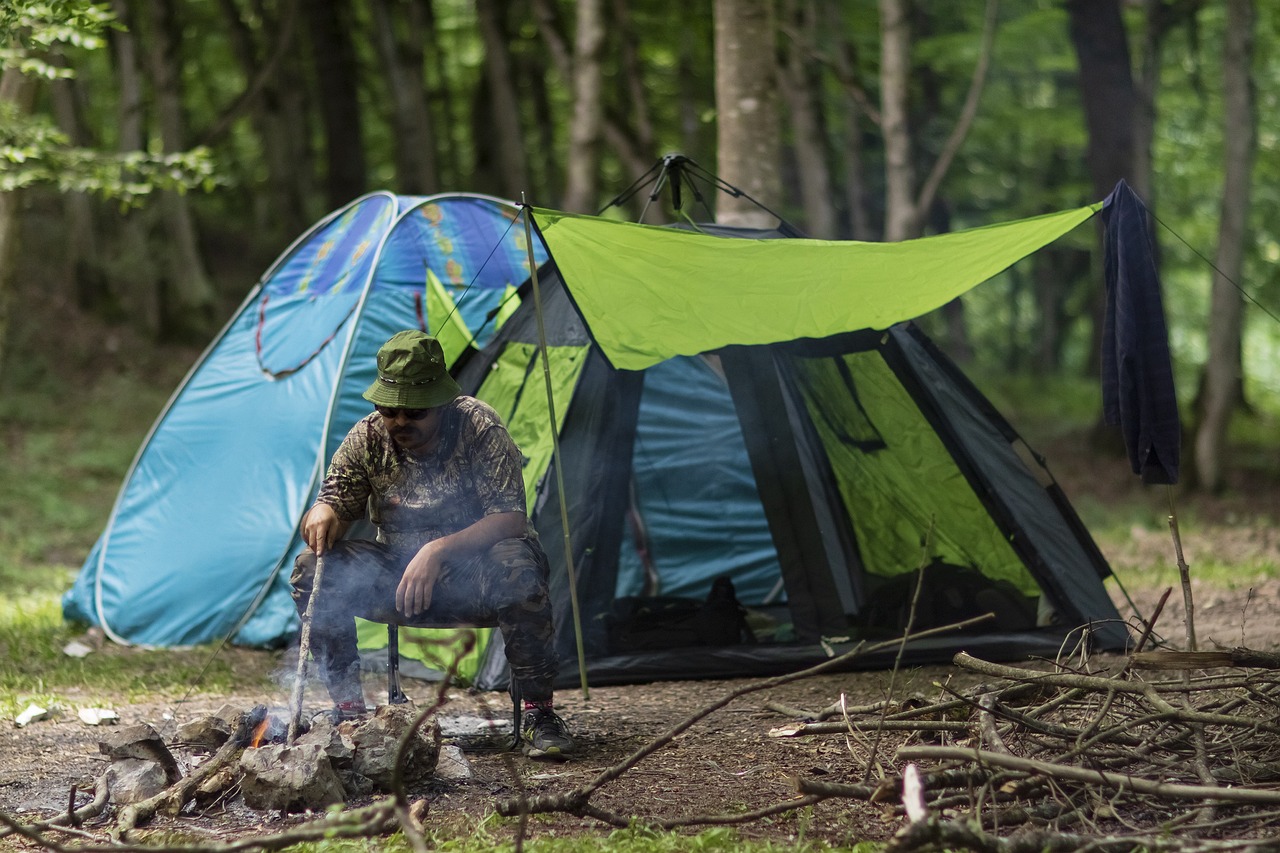 A man sat in front of his tent 