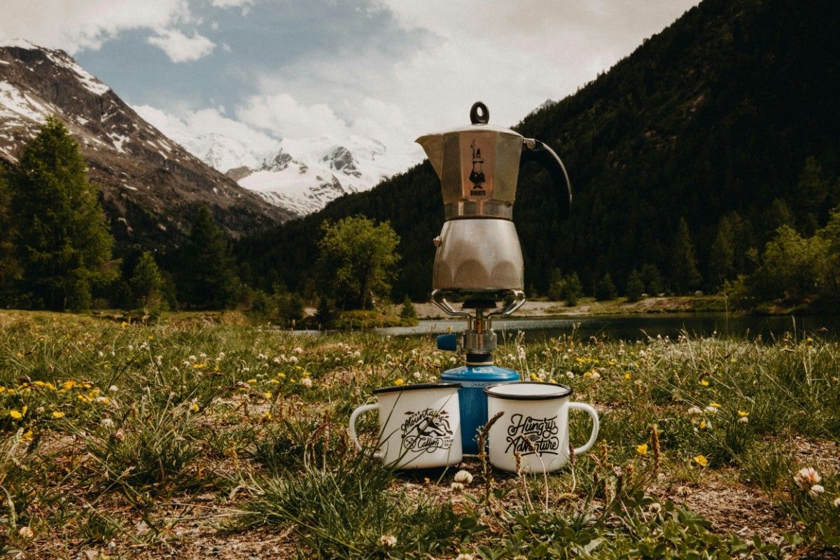 Camp stove with a camp kettle on top