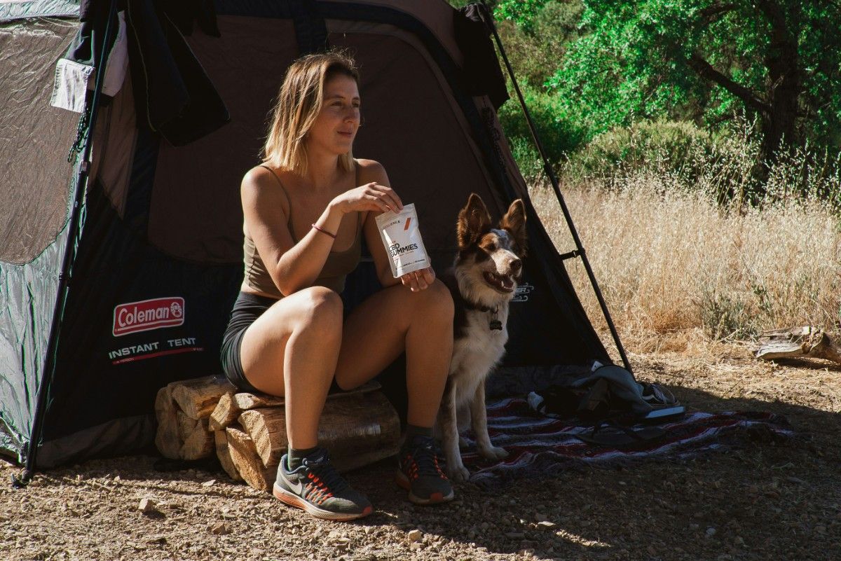 A dog and woman in a tent 