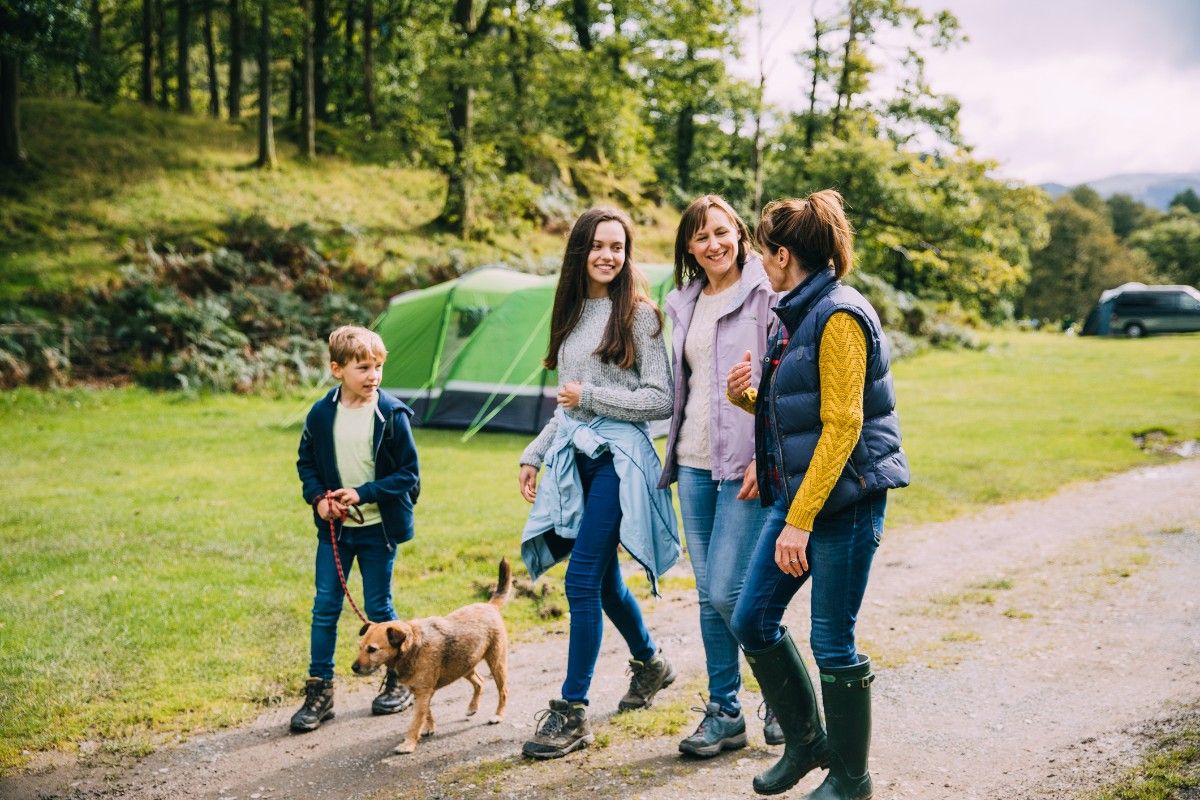 People walking through a campsite 