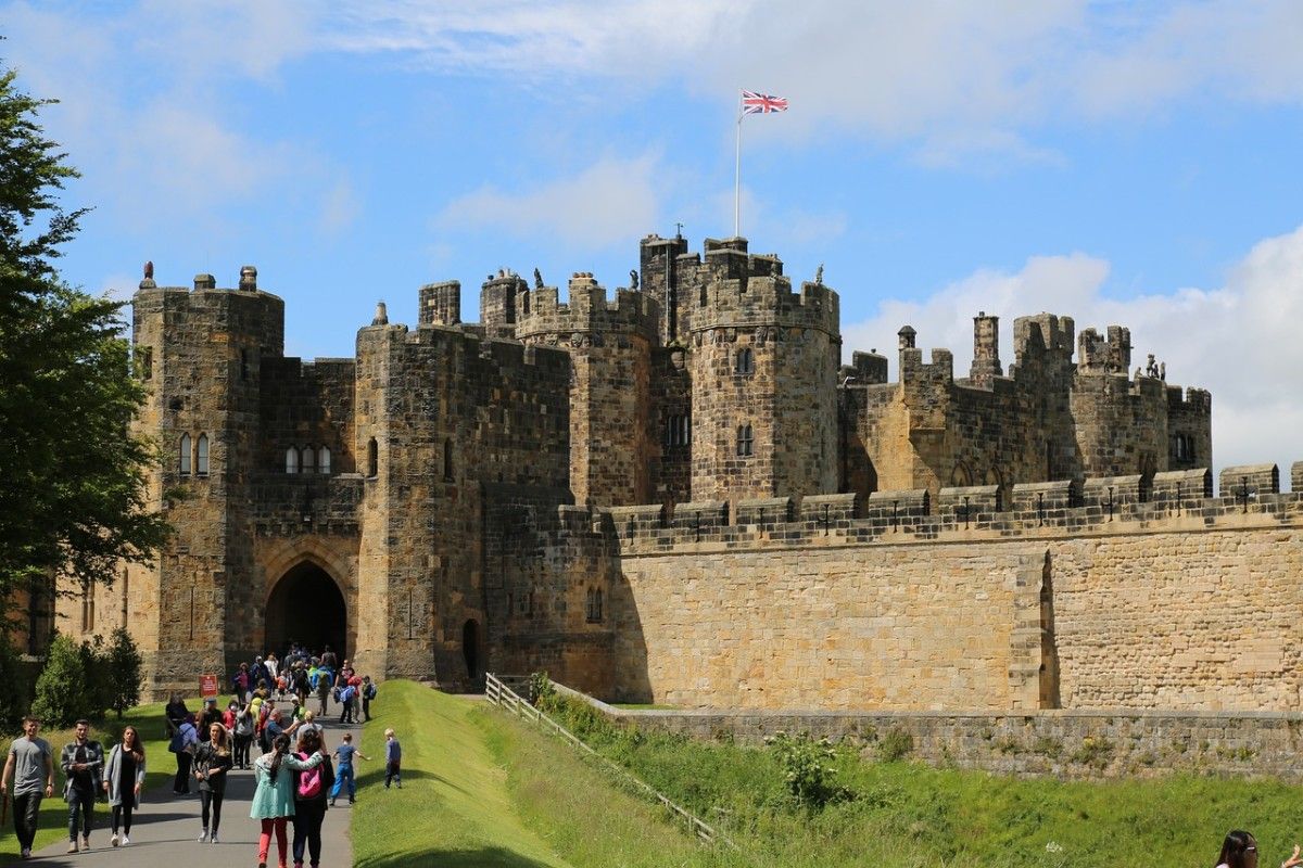 A crowd walking into Alnwick Castle