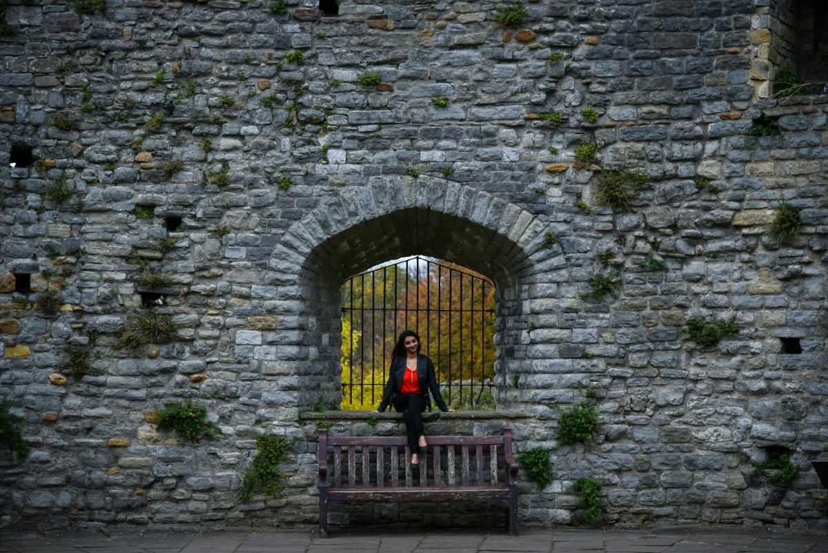 A woman sat on a wall at Cardiff Castle