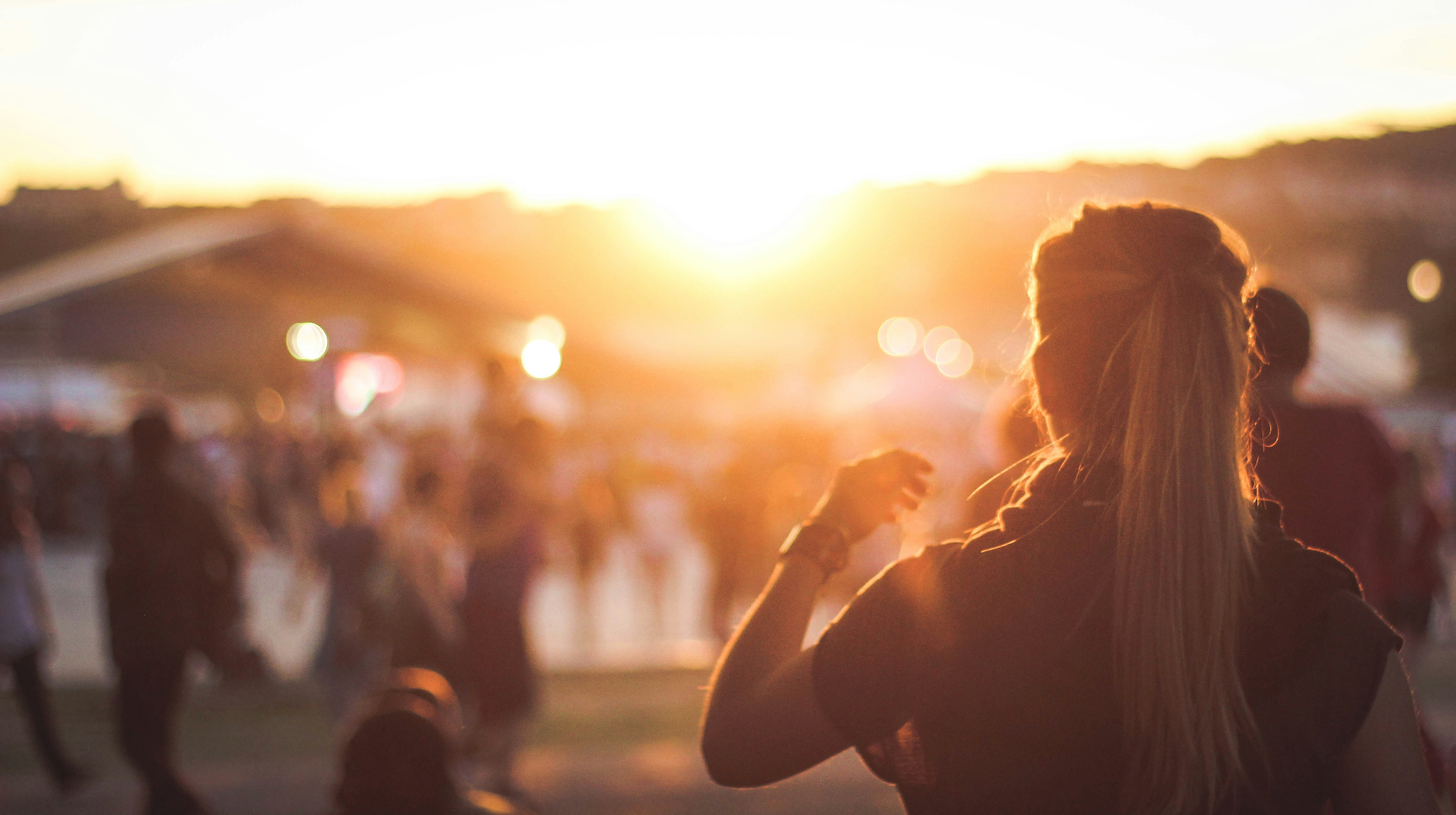 A woman dancing as the sun sets over the festival