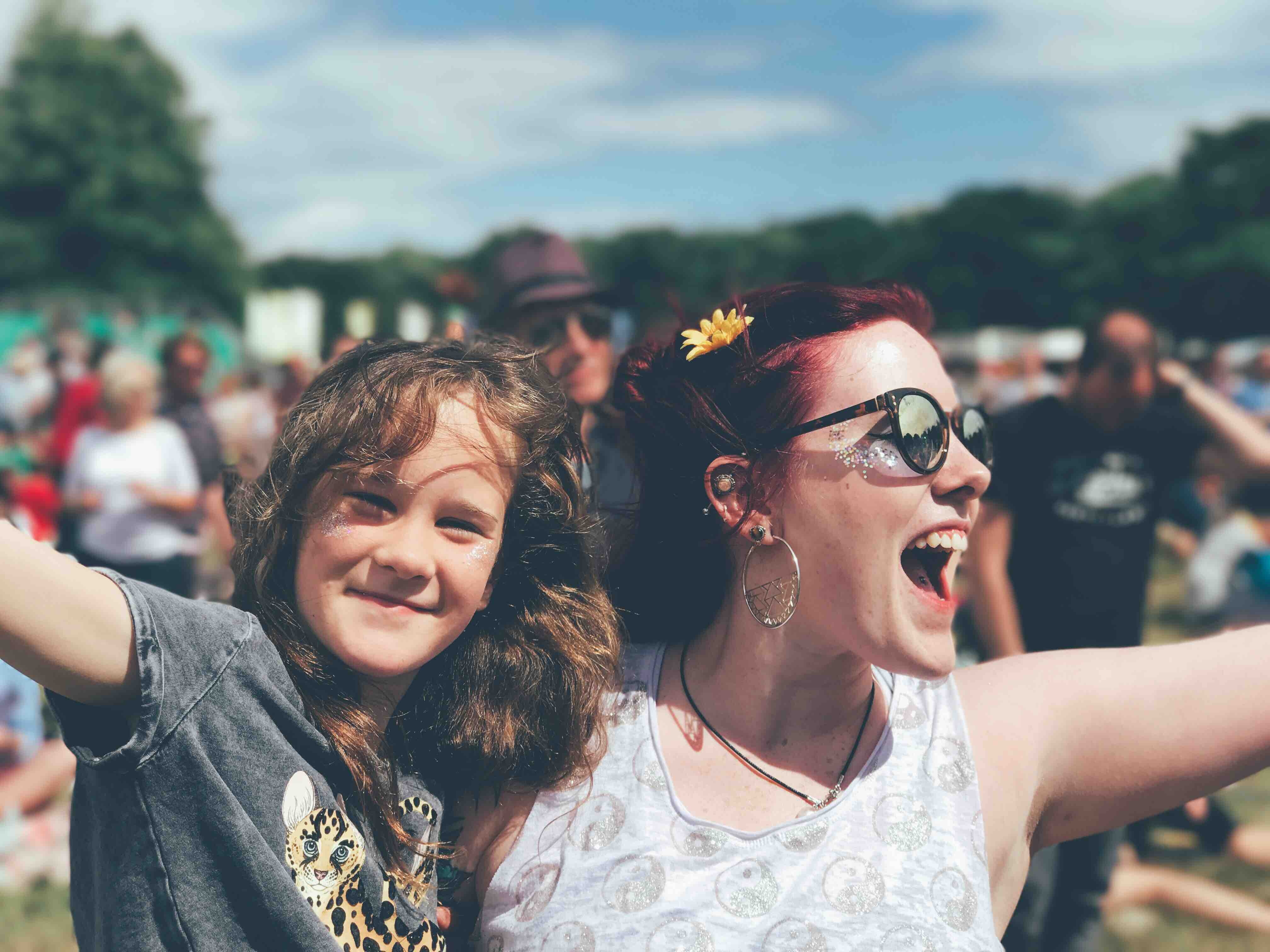 A mother and daughter singing along to an act at the festival 