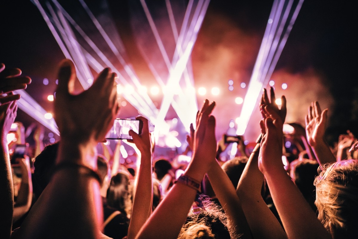 A festival crowd dancing in the lights