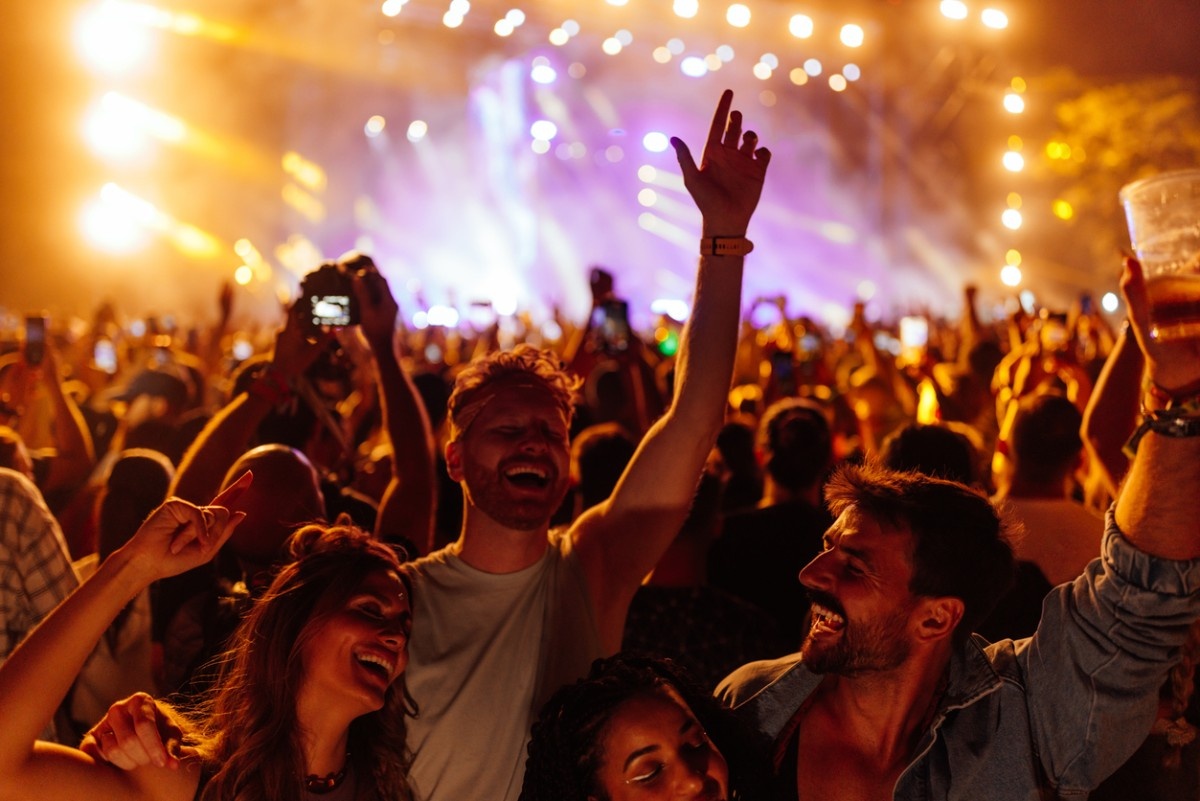 A group of friends dancing together at the festival 