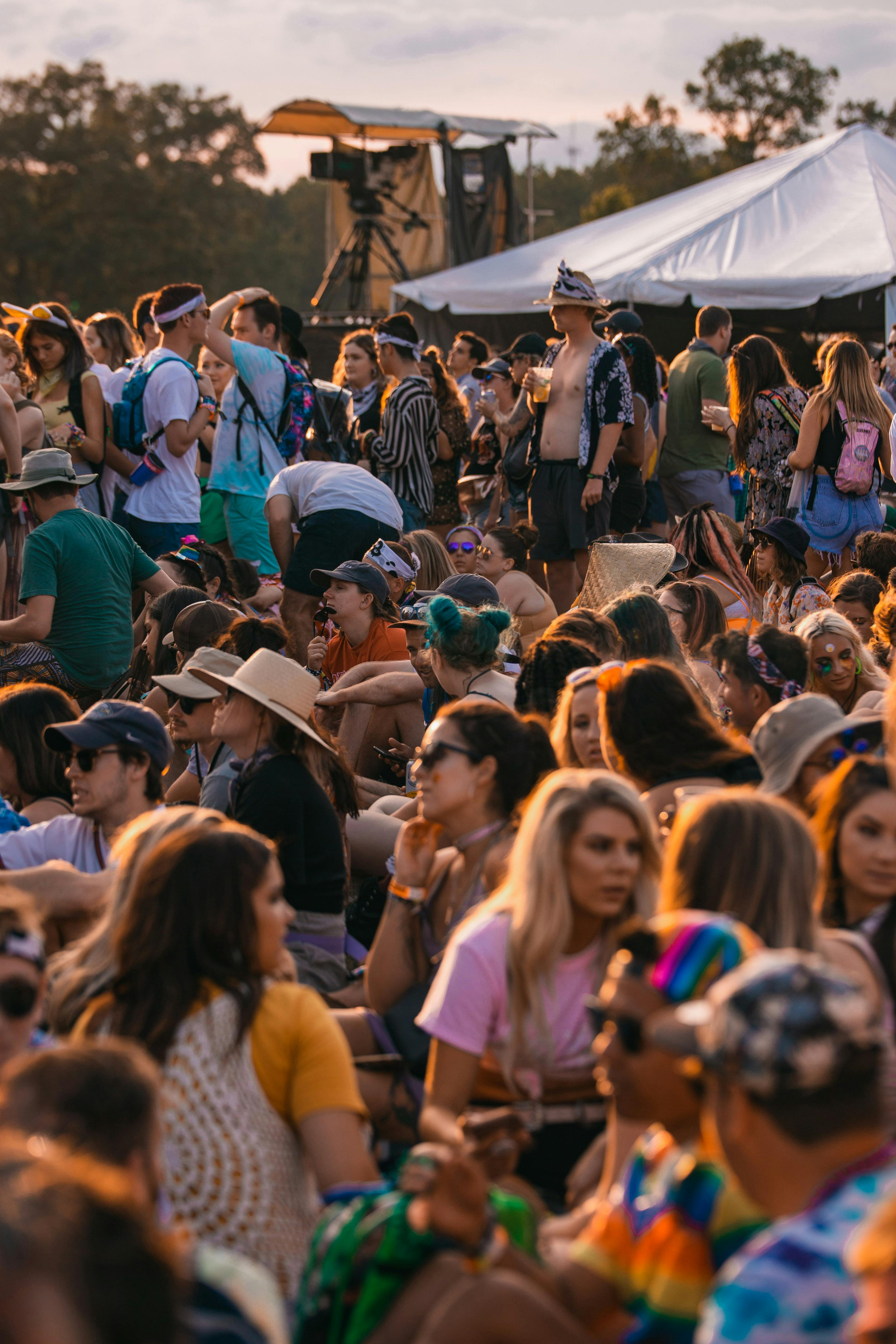 A group of people sat around at the festival 