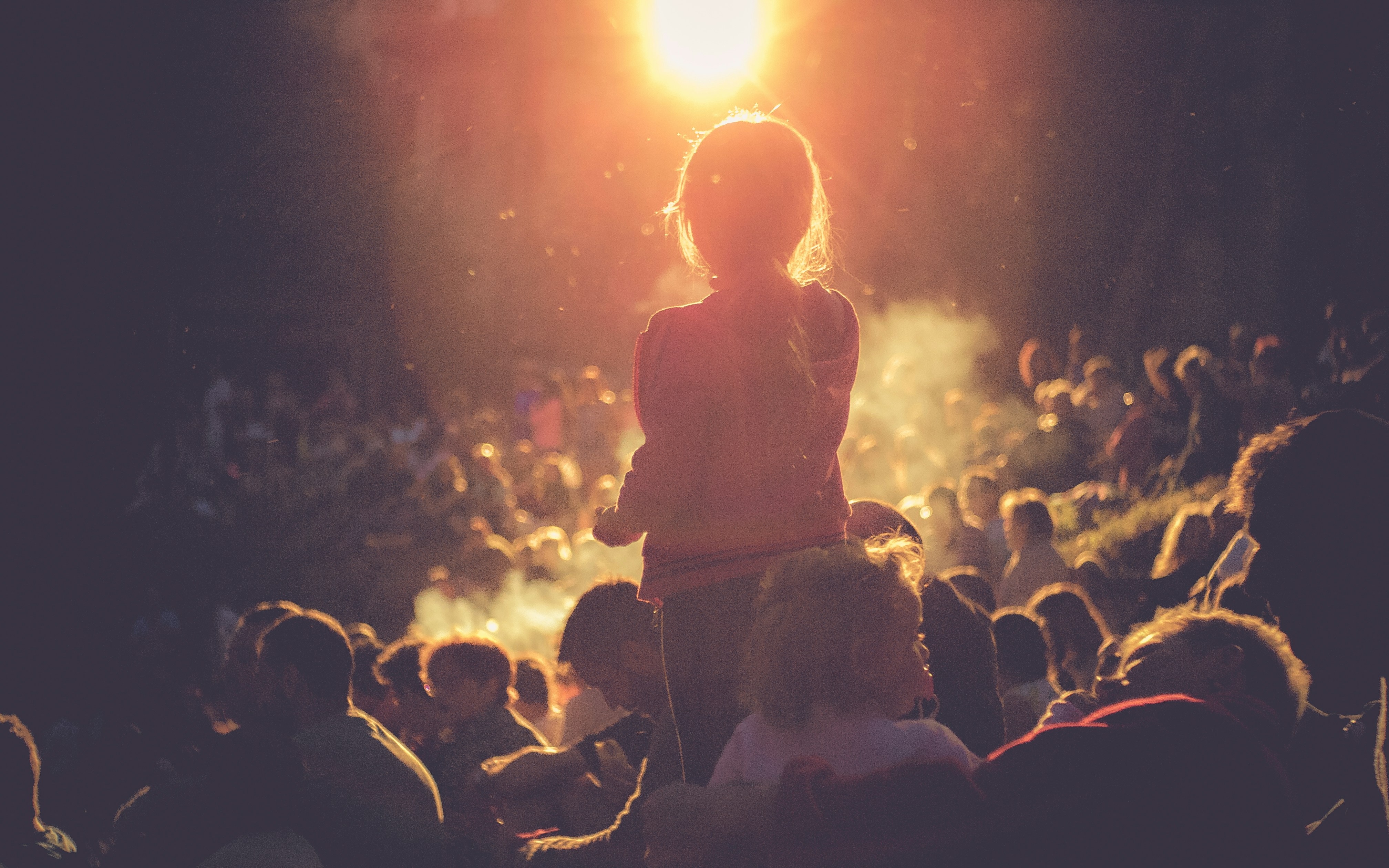 A child at the festival in front of a campfire 