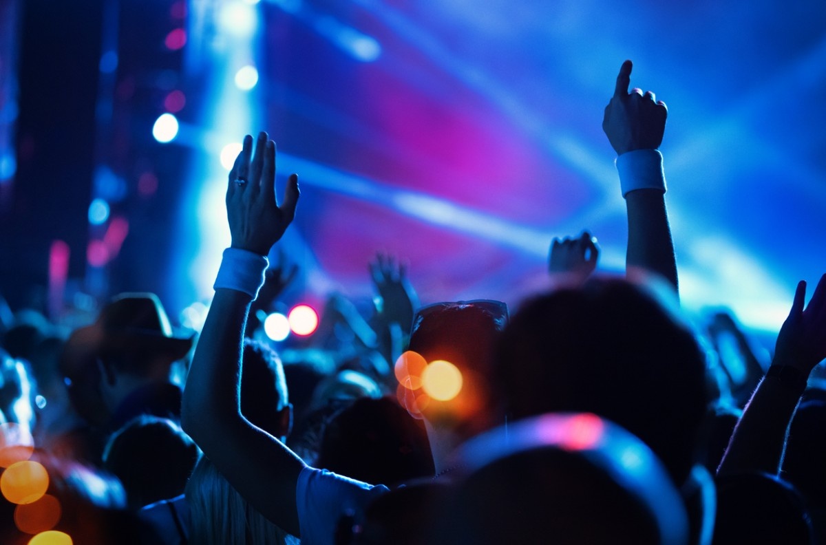 A crowd dancing to a DJ 