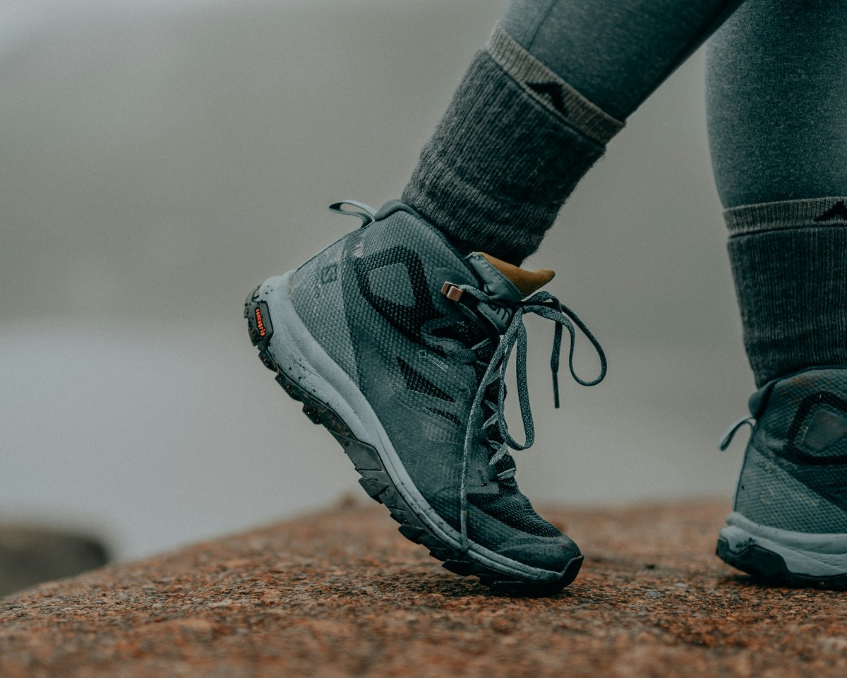 A woman wearing hiking socks with her boots