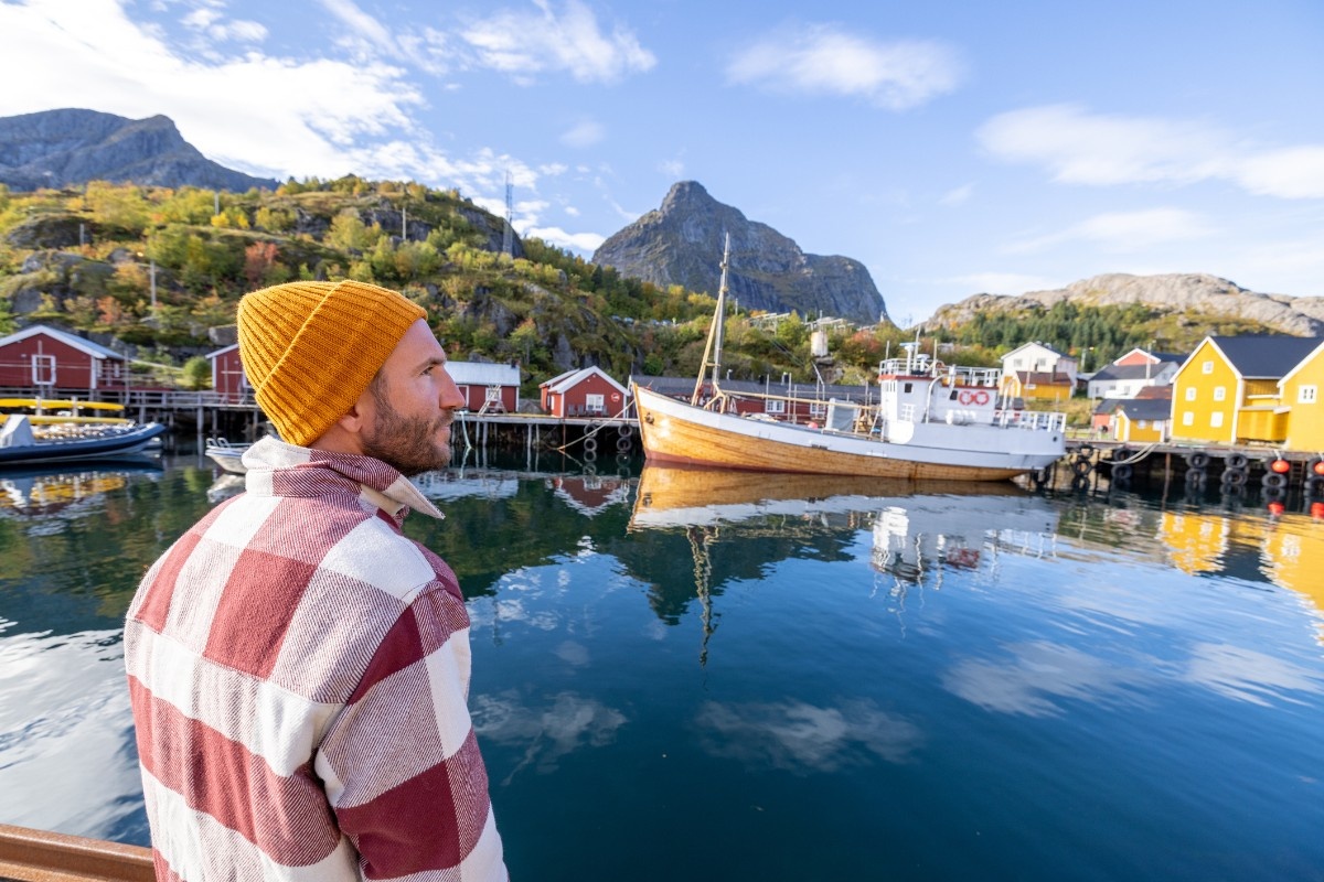 A man visiting a fishing village on the Lofoten Islands