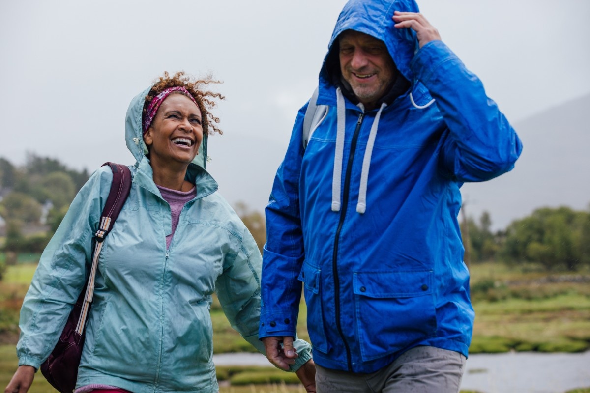 A husband and wife walking in the rain 