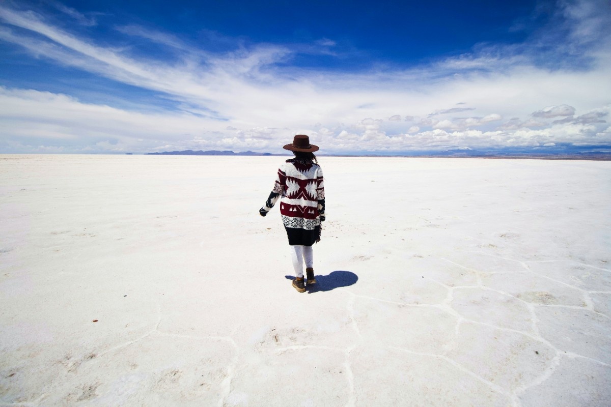 A woman walking on the Salar de Uyuni salt flats in Bolivia