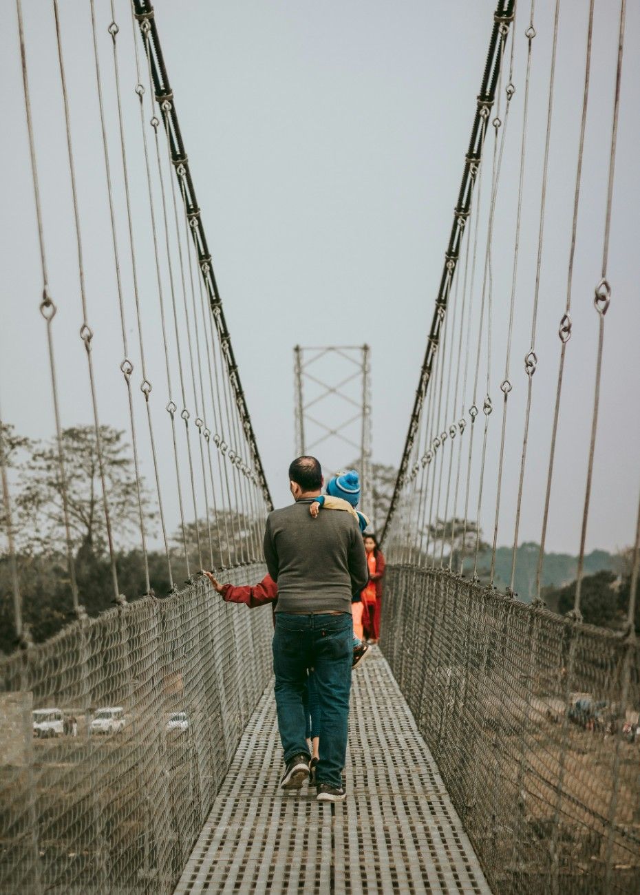 People on a bridge through Chitwan National Park