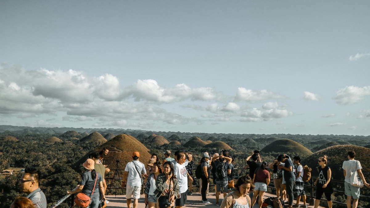 A group of tourists in front of the Chocolate Hills