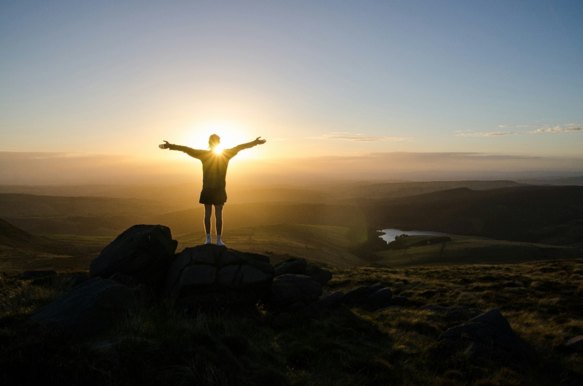 A person stood at the summit of Kinder Scout at sunrise 