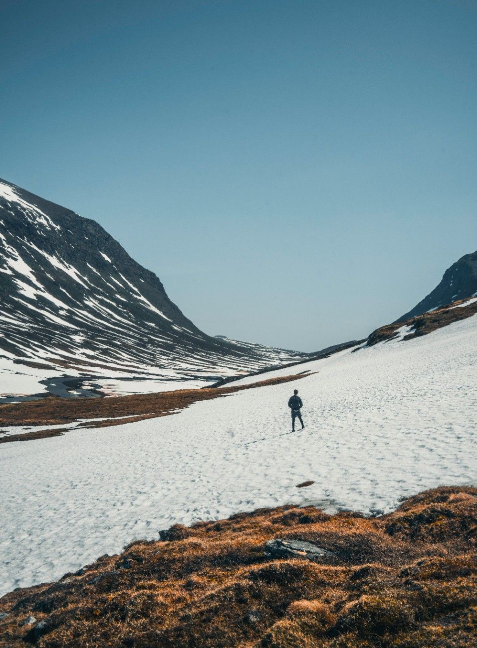 A person hiking in the snow on The Kungsleden Trail