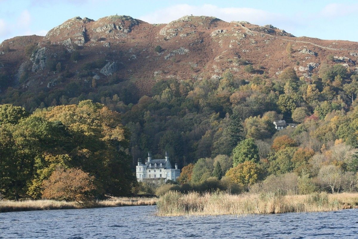 Lake Windermere with a house and hills in the background