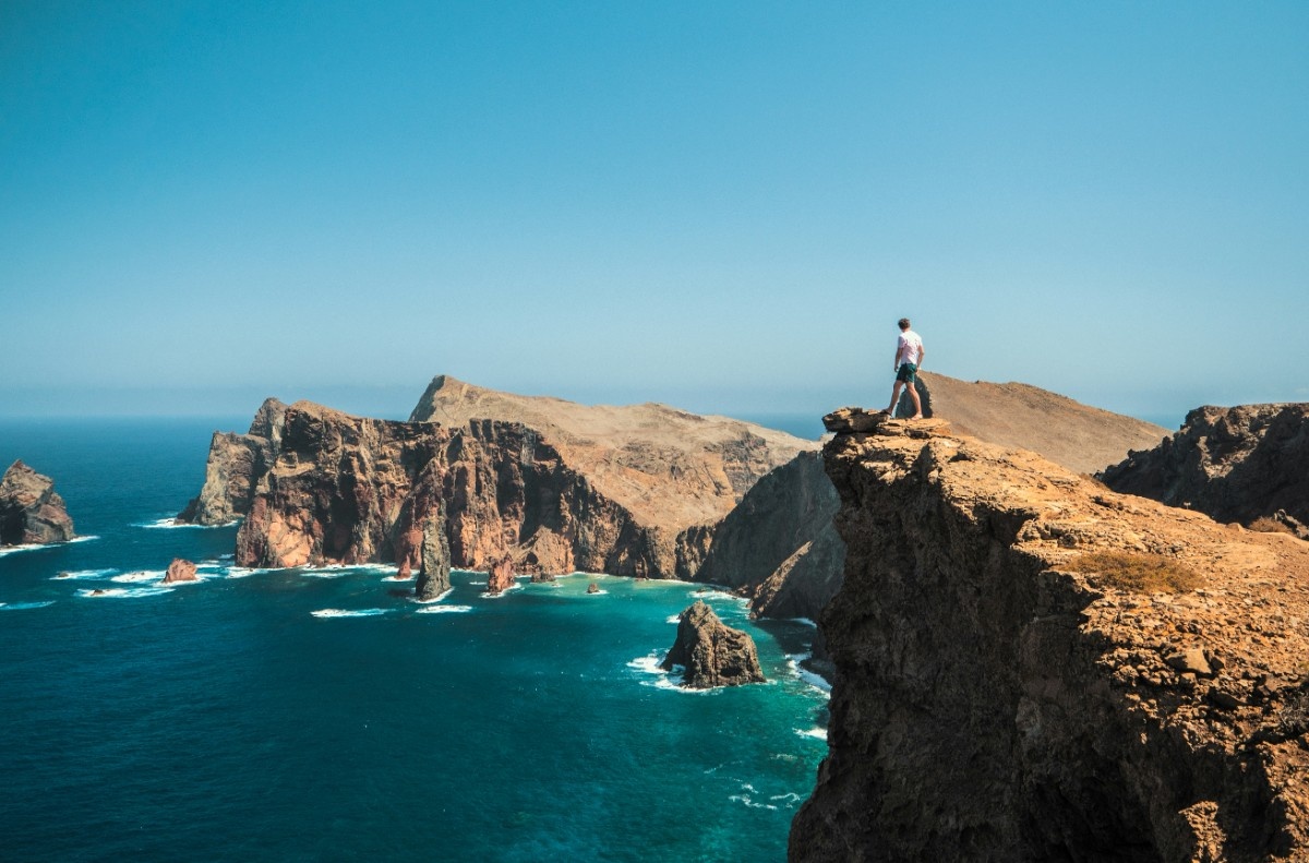 A man stood on the edge of a cliff on a hike in Madeira