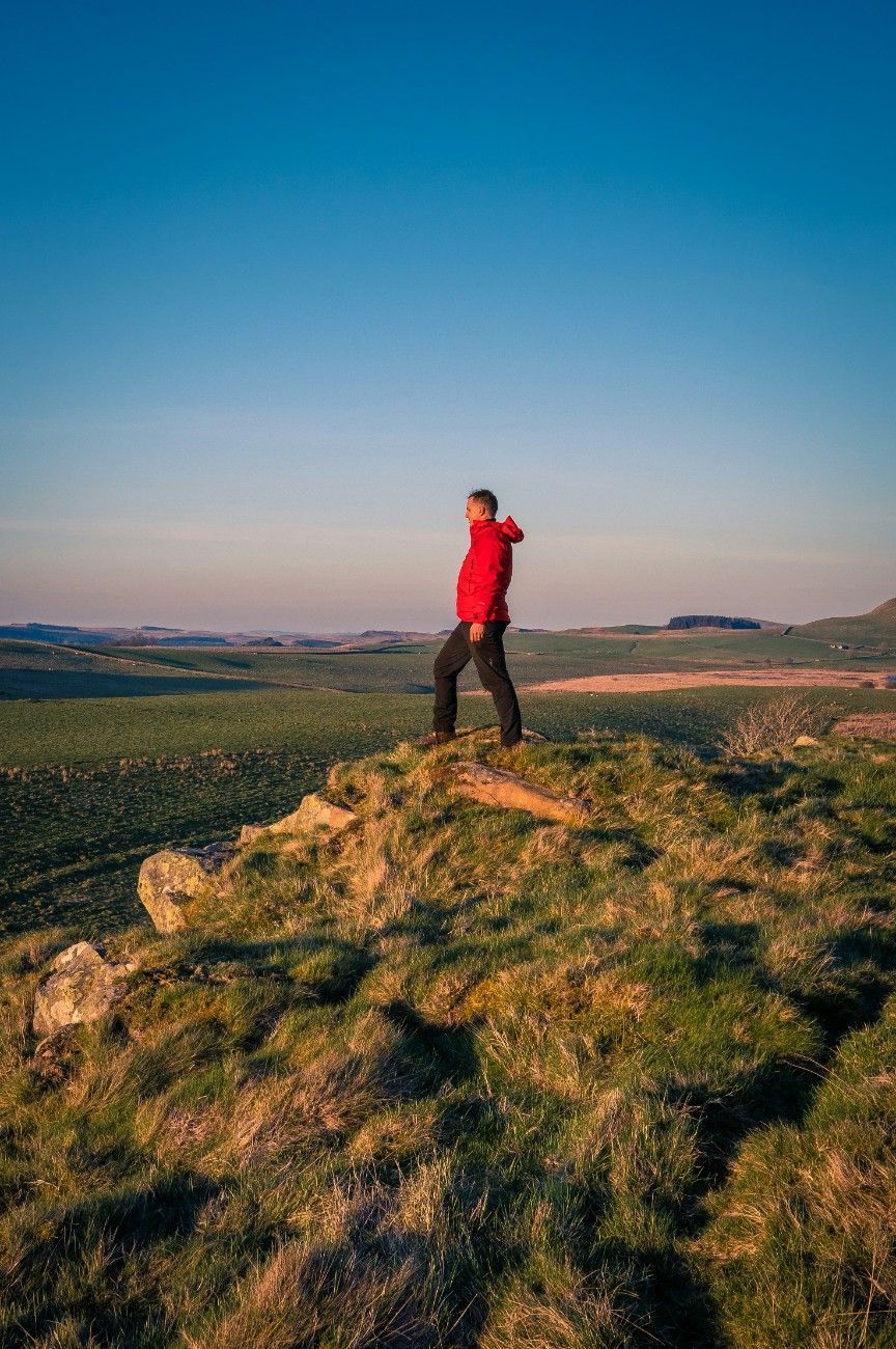 A man on a hill in Northumberland National Park 