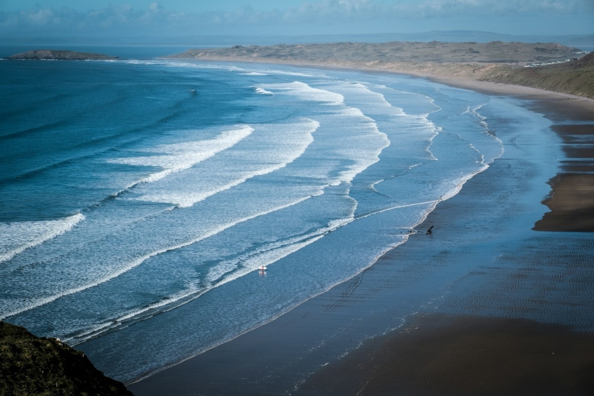 The waves swelling on the beach of Rhossili Bay