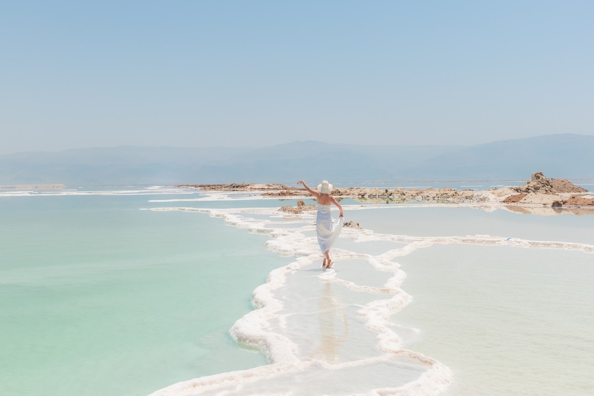 A woman walking through the waters of The Dead Sea