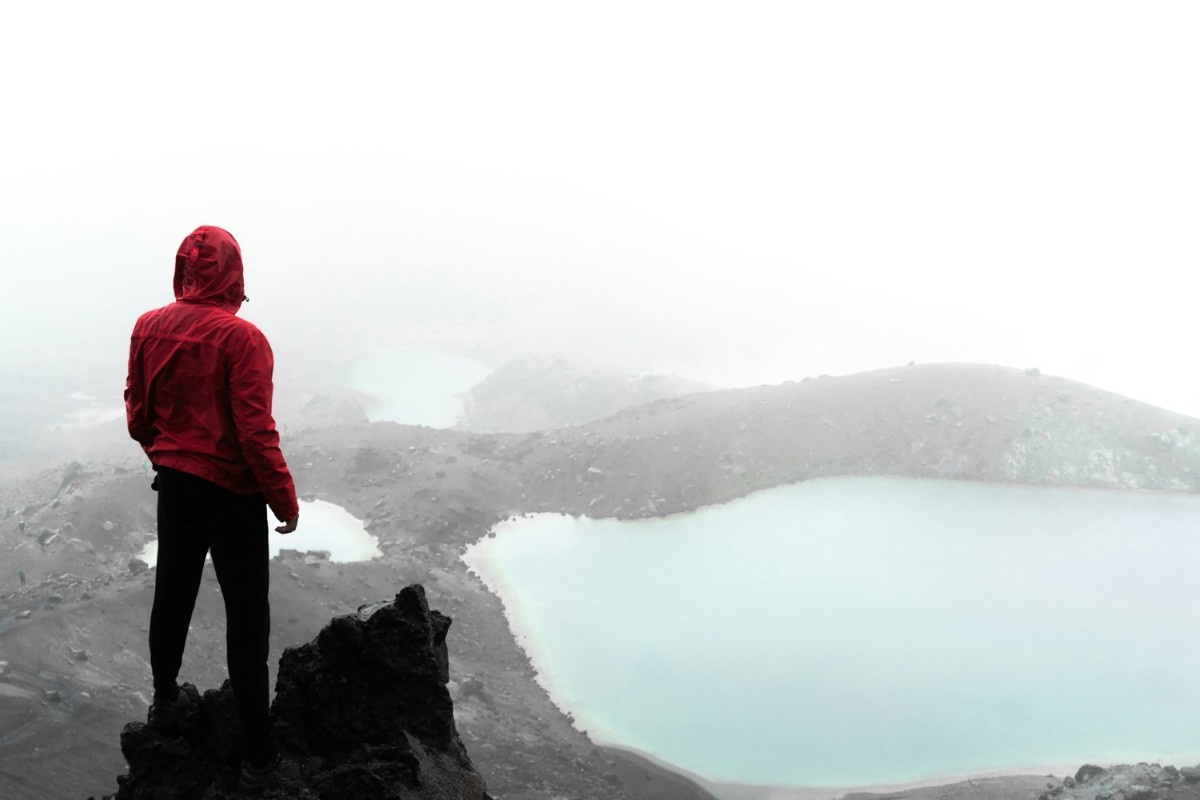 A man admiring the view after hiking up Trolltunga in Norway 