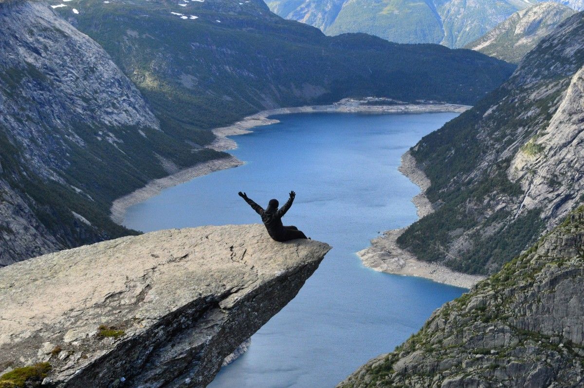 A person sat on the edge of Trolltunga in Norway