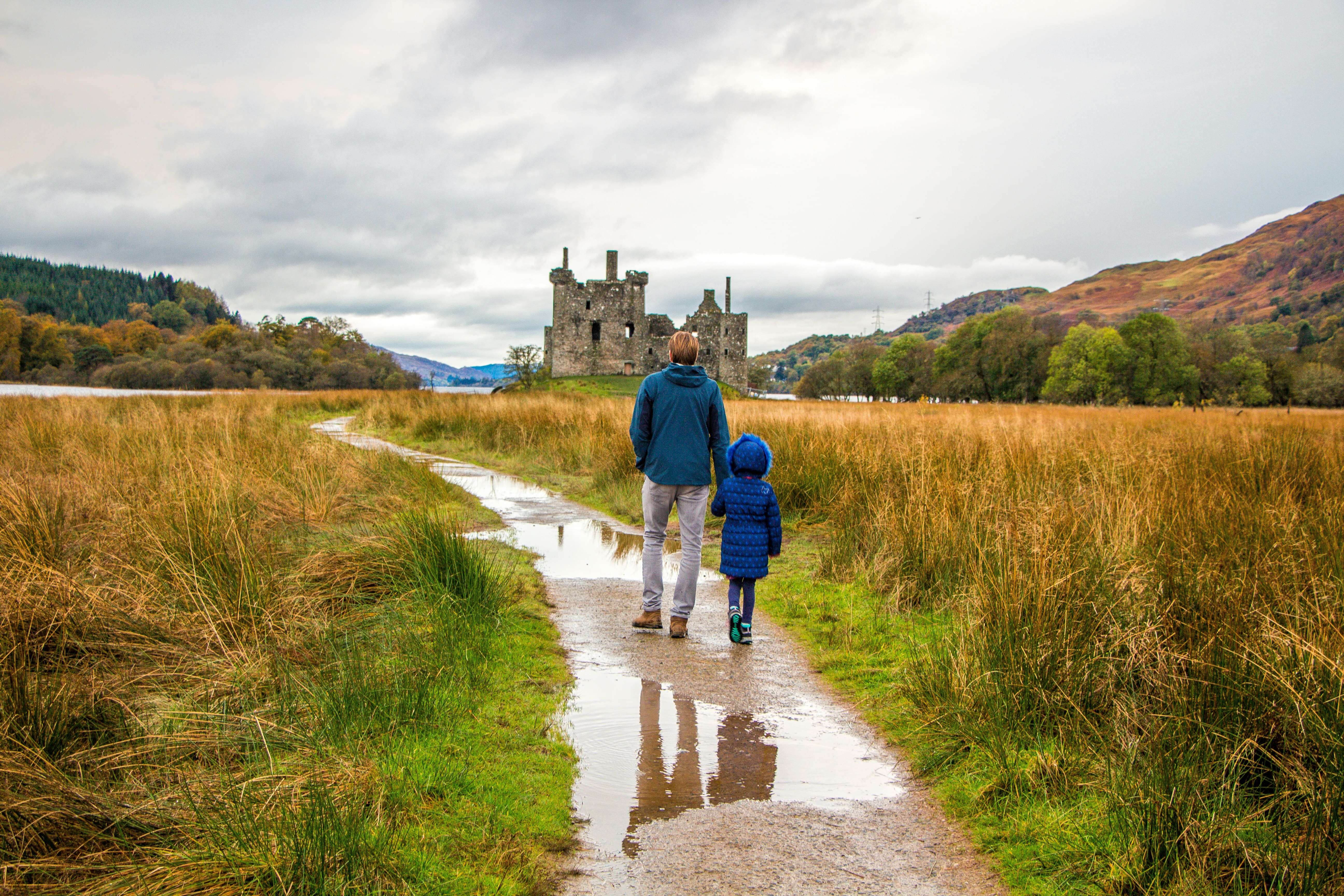 Parent and infant walking towards the castle