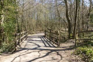 Ashdown Forest, East Sussex, England, UK, is the inspiration for the 'Winnie the Pooh' stories by AA Milne and is known as 'The Hundred Acre Wood' in the stories.  This is NOT the bridge that Christopher Robin played 'Pooh Sticks' from it is one that is 50 yards from it.