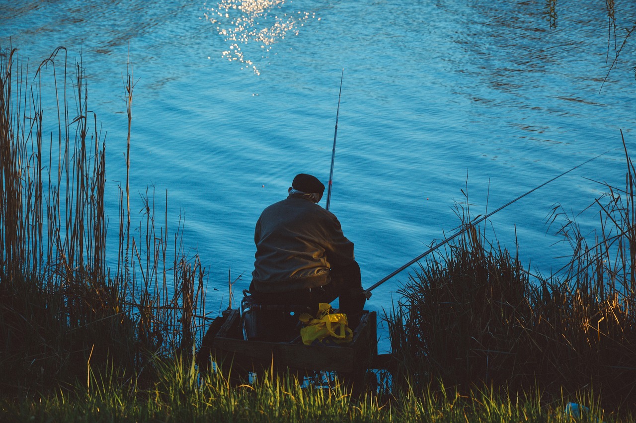 Man relaxing and fishing by lakeside