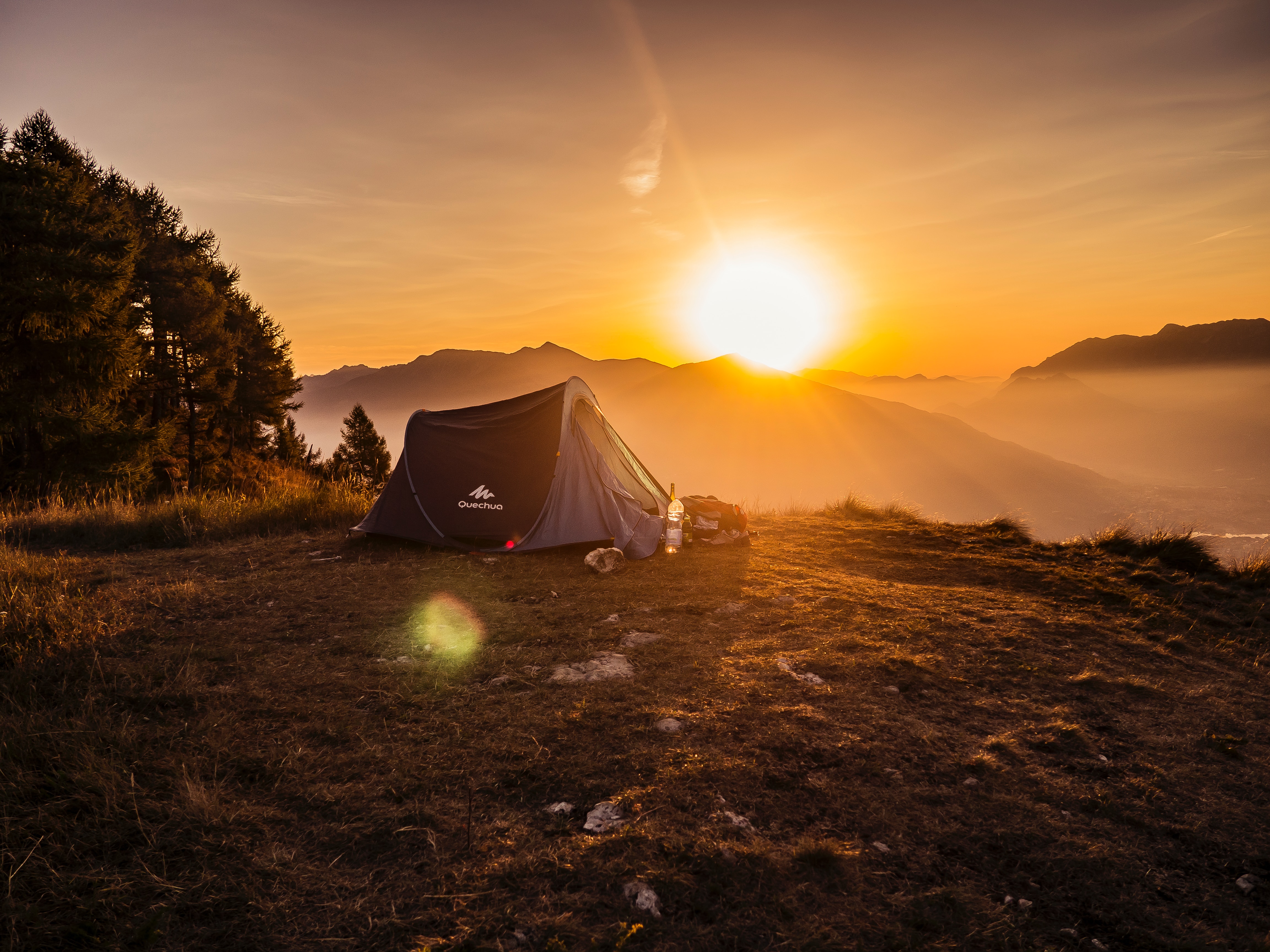 A woman and a man are pitching a tent