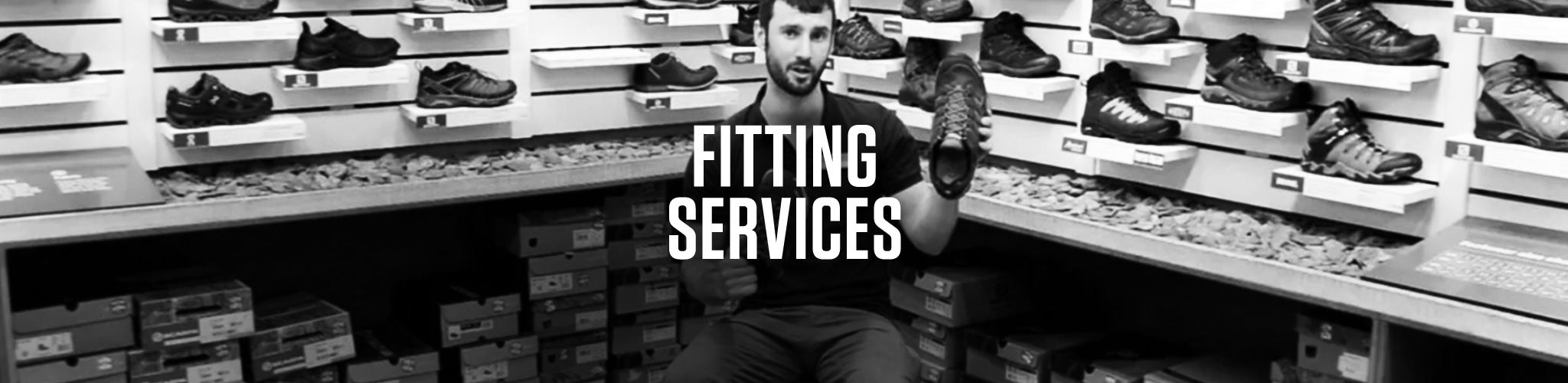 Fitting Servises on a shop assistant, showing walking shoes, background