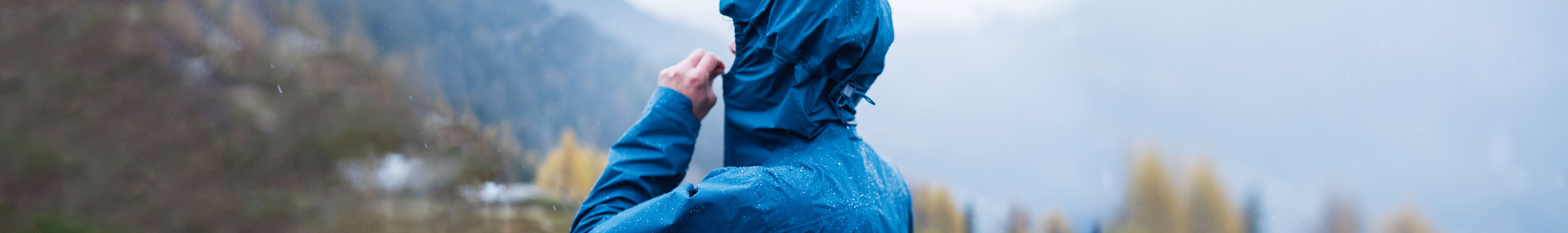 A woman wearing a waterproof jacket in the rain 